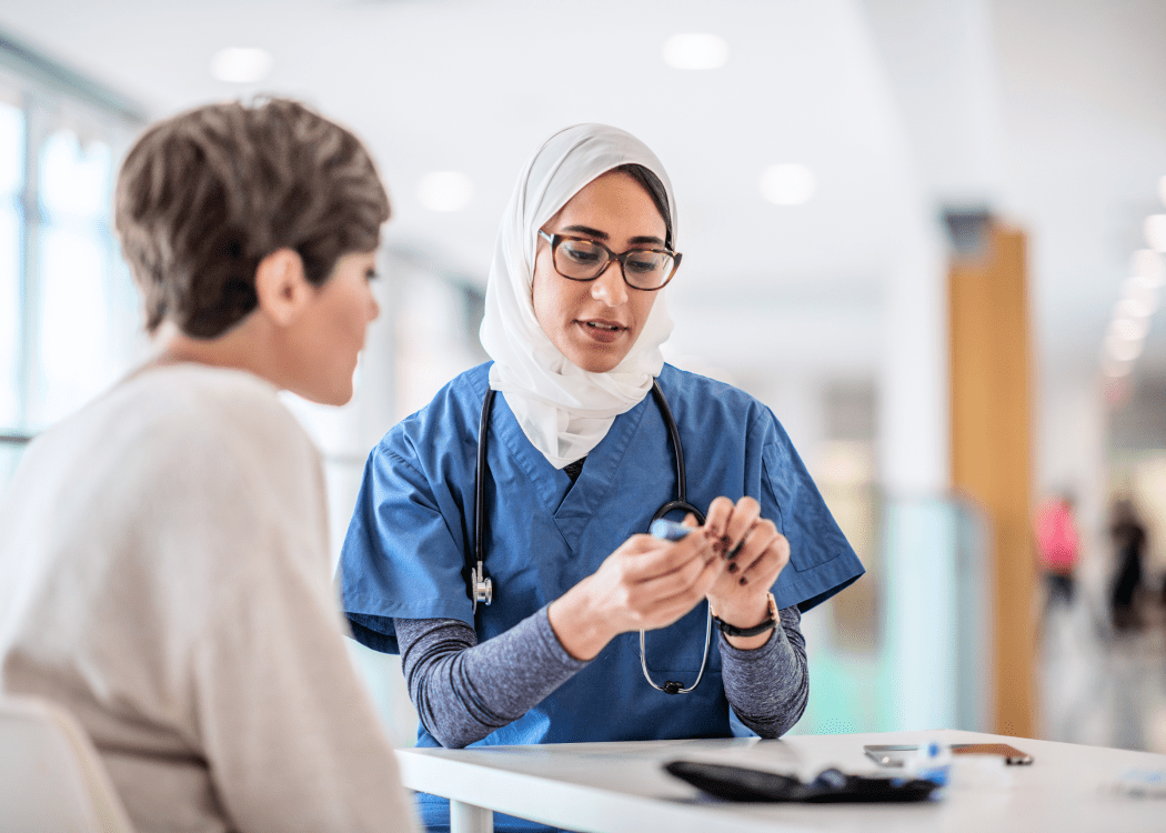 A pharmacist helps a customer at a counter.